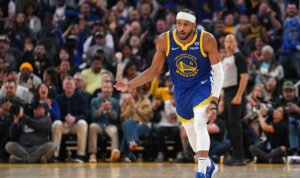 Warriors Moses Moody celebrates a three pointer